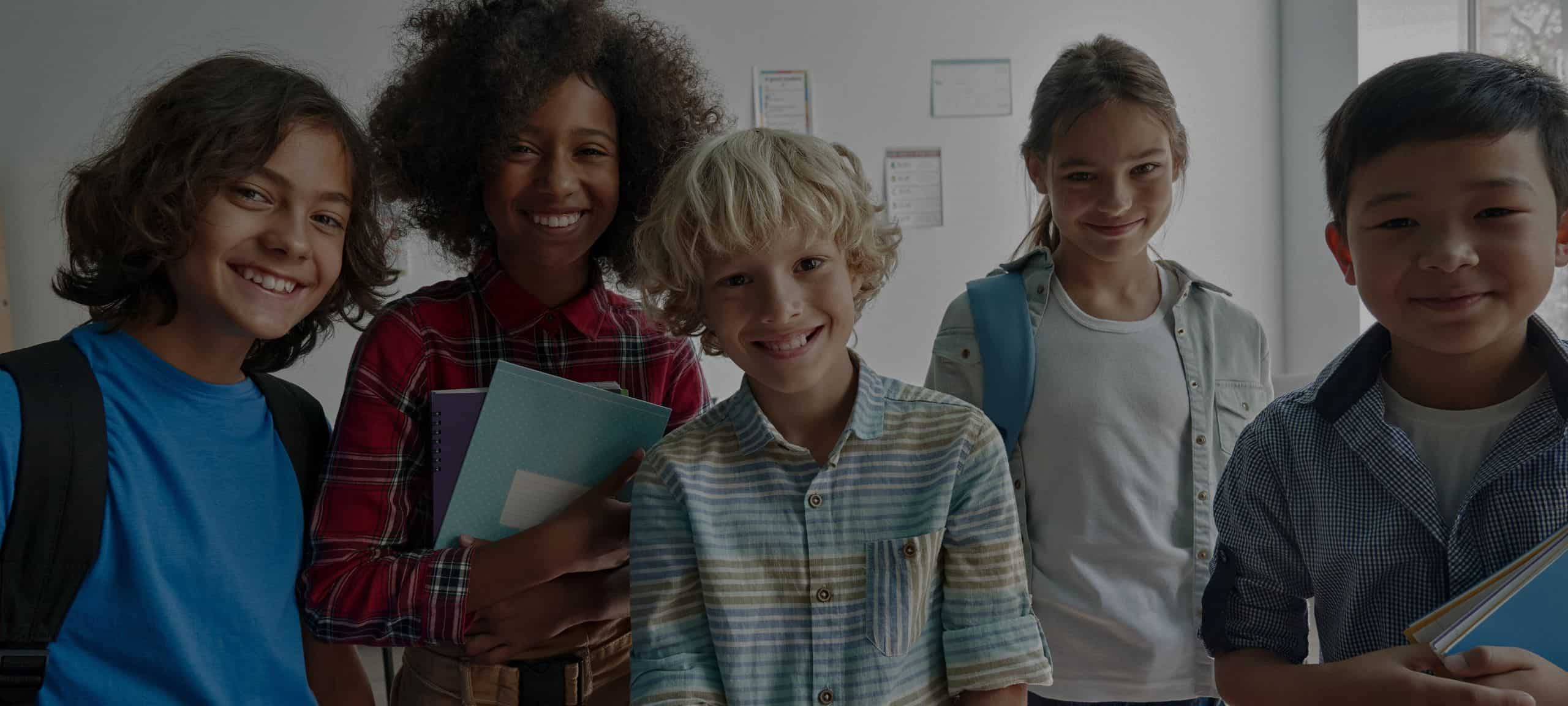 Middle School students carrying books and backpacks